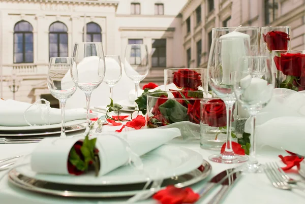 Gedekt feestzaal met rode rozen decoratie — Stockfoto