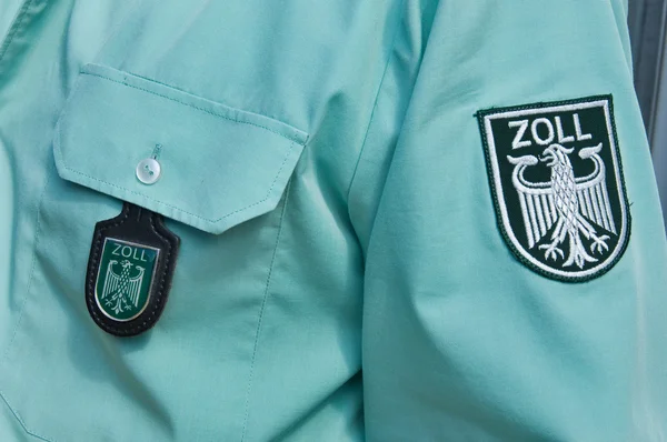 stock image Labels on the shirt of an german customs officer
