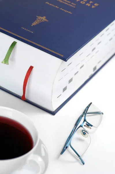 Thick book with reading glasses and bookmark — Stock Photo, Image