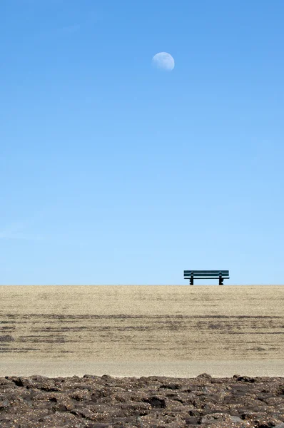 stock image Lonely park bench on a dyke