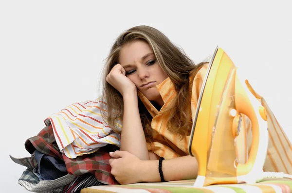 stock image Young frustrated woman at an ironing board