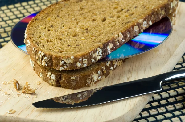Slices of bread with a CD/DVD between them — Stock Photo, Image