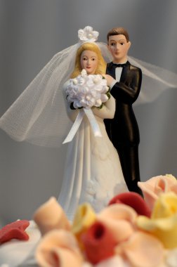 Bridal couple on a wedding cake clipart