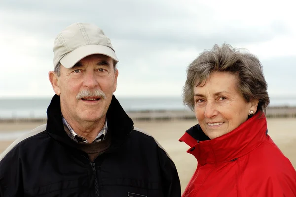 Senior couple on a beach walk Stock Image