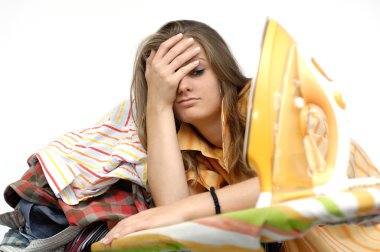 Frustrated young woman at the ironing board clipart