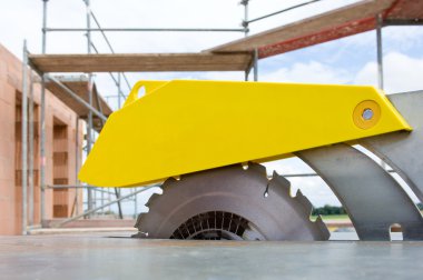 Circular saw on a construction site clipart