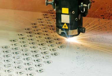 Industrial laser cutter at work clipart