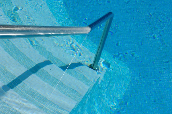 Steps ans handrail into a swimming pool — Stock Photo, Image