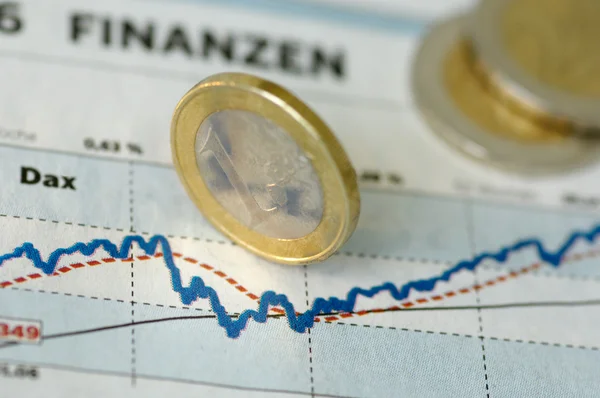 Euro coins on a finance chart — 图库照片