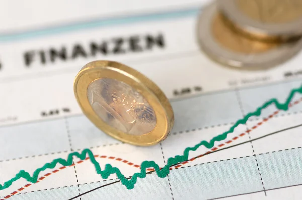 Euro coins on a finance chart — 图库照片