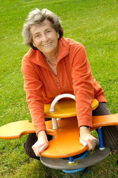 Senior woman on a playground — Stock Photo, Image