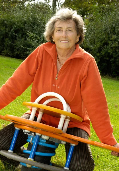 Senior woman on a playground — Stock Photo, Image