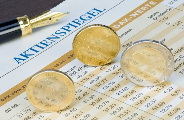 Euro coins on a finance chart — Stock Photo, Image