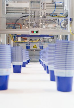 Mass production of plastic cups clipart