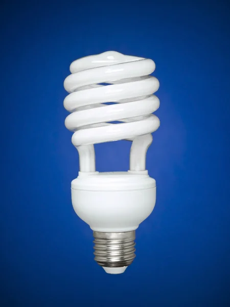 Fluorescent light bulb over blue — Stock Photo, Image