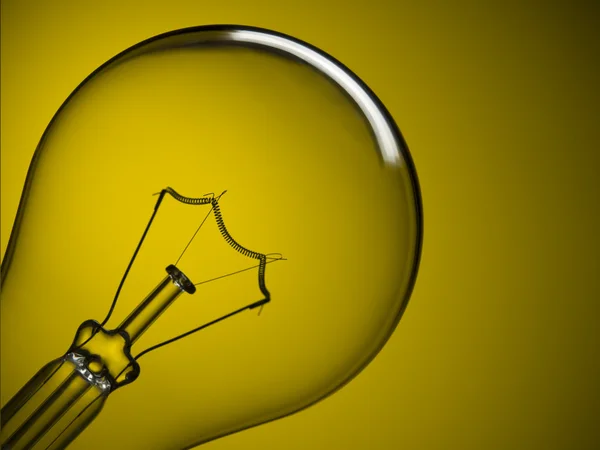 Light bulb over yellow — Stock Photo, Image