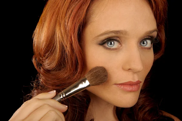 Kvinna applicerar makeup — Stockfoto