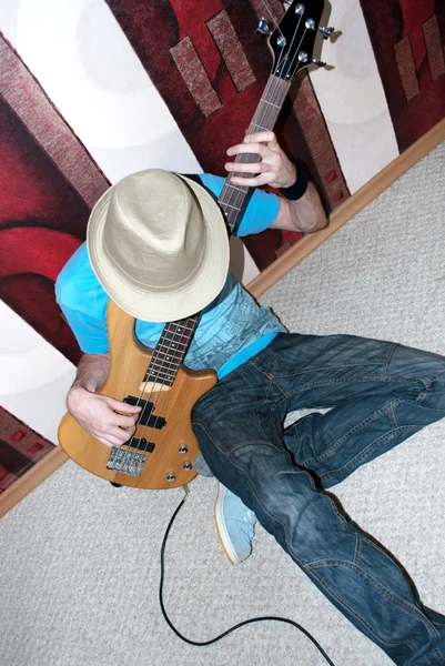 A young man with a bass guitar — Stock Photo, Image