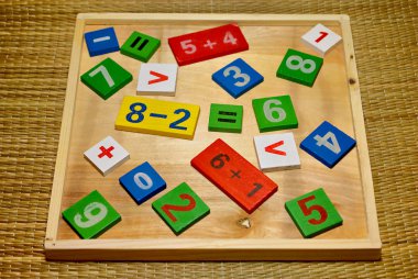 Children's colored wooden set for the study of mathematics. Cheerful learning toys. clipart