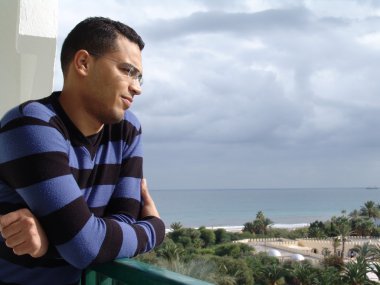Tunisian man watching the ocean clipart