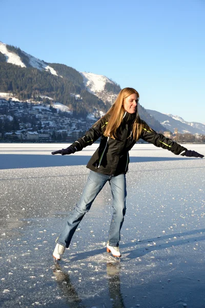 stock image Pirouette of young woman figure skating at frozen lake of zell am see in austria