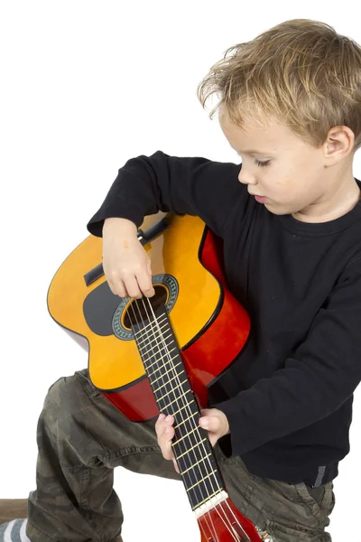 stock image Little boy is composing music on a white background.