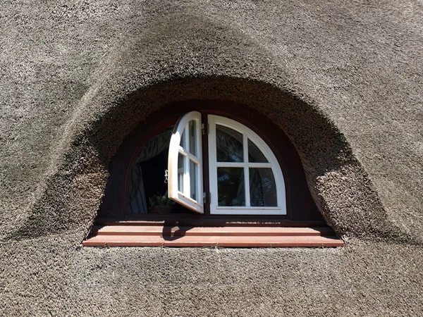 stock image Nice window in a house with a reed roof