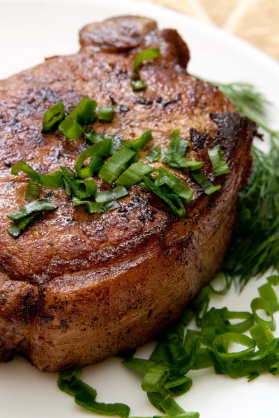 Stock image Delicious fried steak with herbs