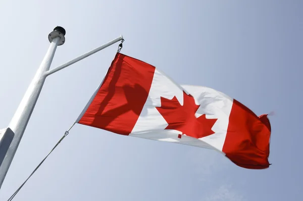 Canadian flag fluttering. On a mat boat