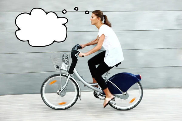 Young woman on a bike thinking — Stock Photo, Image