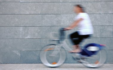 Woman rushing on a bike clipart