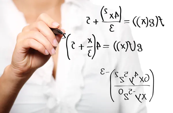Toung teacher solving a mathematical equation — Stock Photo, Image