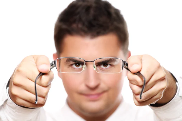 Joven empresario sosteniendo gafas —  Fotos de Stock