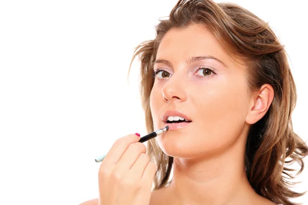 Beautiful woman putting on makeup Stock Photo