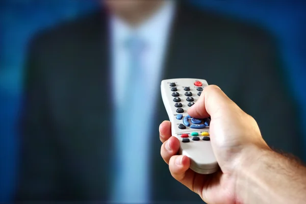 Male hand holding a remote control — Stock Photo, Image