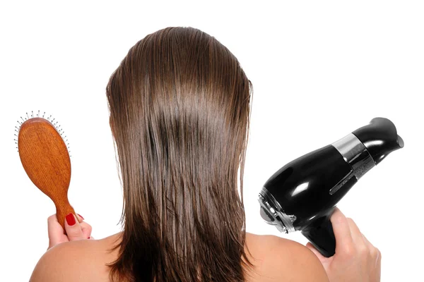 Fiatal nő és egy hajszárítóval felszerelt, és a hajkefe — Stock Fotó