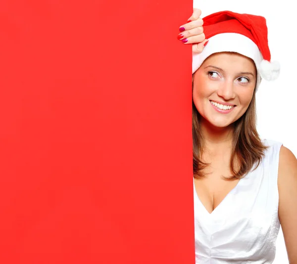 Mulher de chapéu de Pai Natal segurando uma tábua em branco — Fotografia de Stock