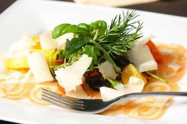 Salmon carpaccio with some extras and fork on the table clipart