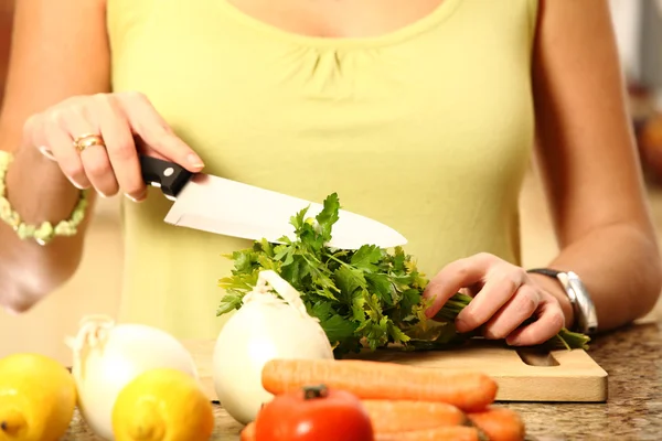 Young wife cutting parsley — Stock Photo, Image