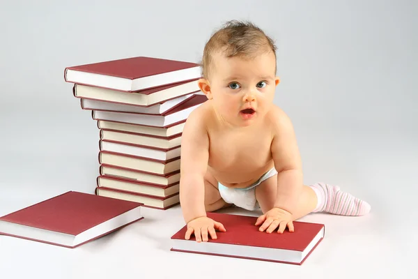 Small baby and books Stock Image
