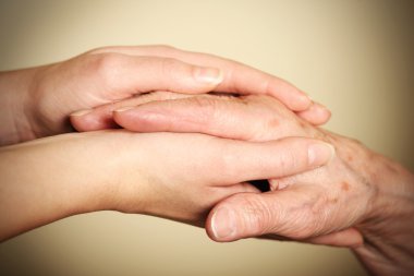 A picture of old and young hands symbolizing help and love clipart