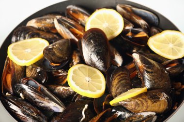 Spanish mussels on a frying pan clipart