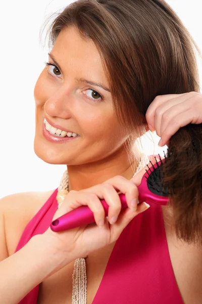 Pretty woman brushing her hair — Stock Photo, Image