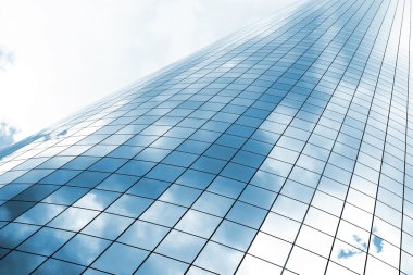 Highrise glass building with skz and clouds reflection clipart