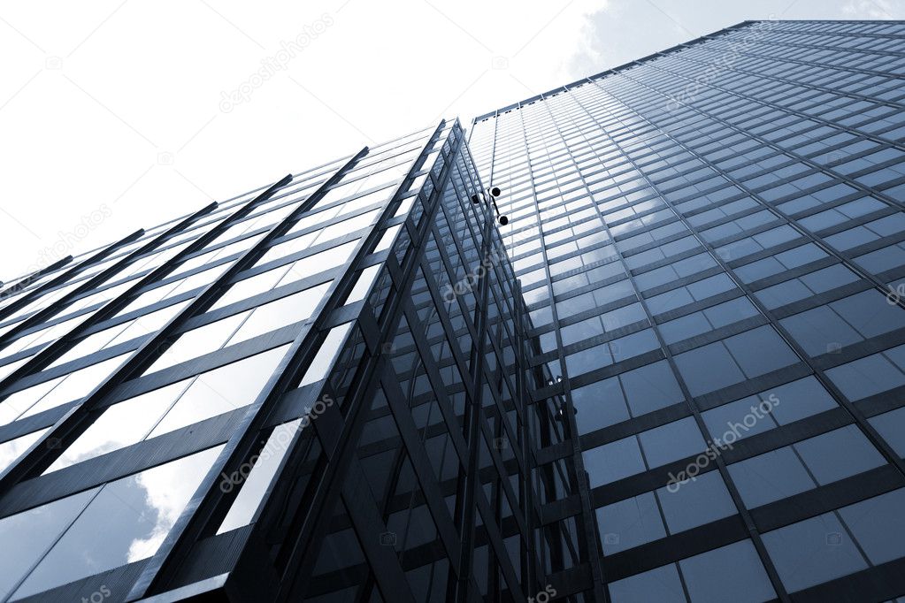 Modern office building with glass walls and white sky