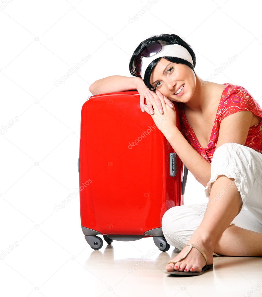 A closeup of a pretty girl in short black hair resting on a suitcase over white background
