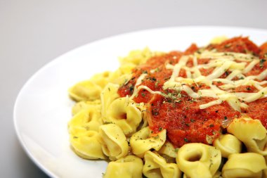 Tortellini with tomato sauce clipart