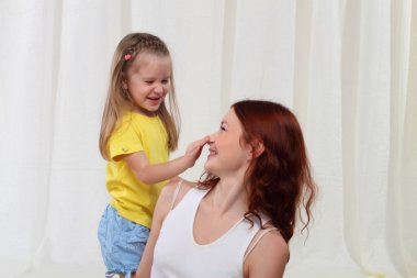 Daughter touching mother's nose clipart