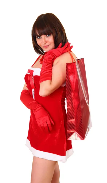 Chica en vestido de santa con bolsas haciendo compras —  Fotos de Stock