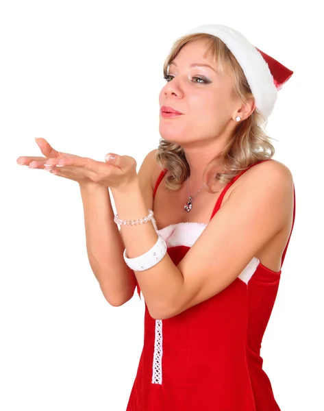 Girl in santa dress blowing something on her hand isolated over a white bac — Stock Photo, Image